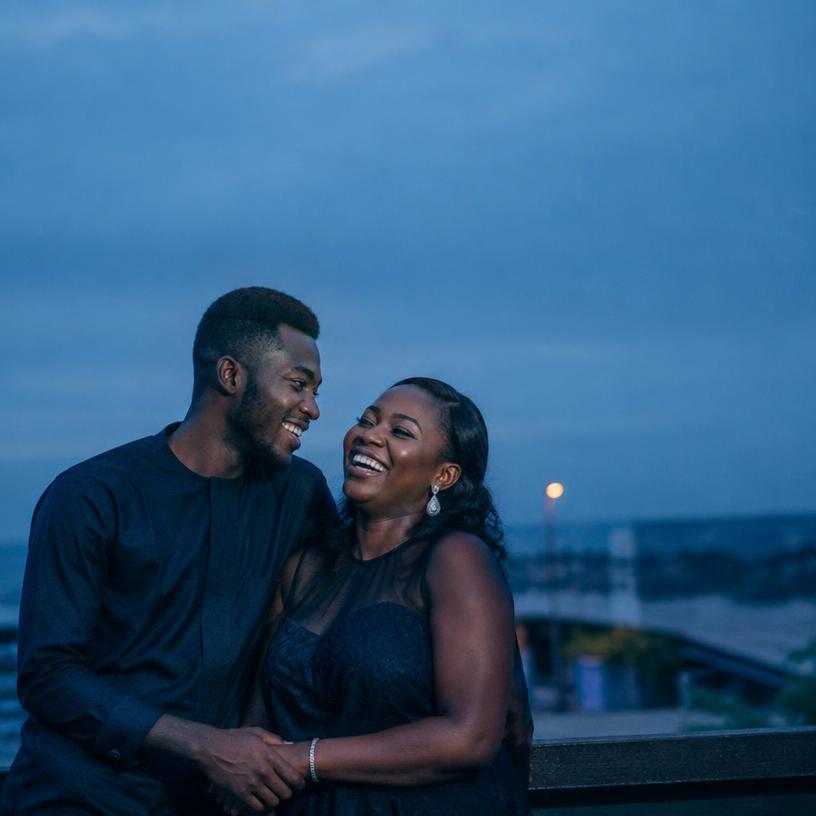 Daniel and Amara laughing together at dusk